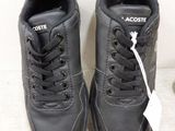 black leather sneakers with laces and a white tag on them