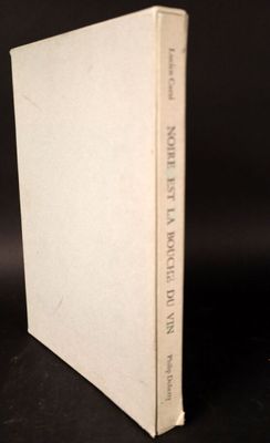 an old book sitting on top of a table next to a black background