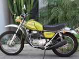 a green motorcycle parked in front of a building