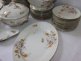 a lot of plates and bowls on the table