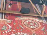a red rug with a floral design on it