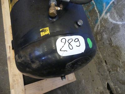 a black air compressor sitting on top of a wooden pallet