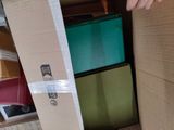 a person opening a cardboard box with a pair of scissors in it