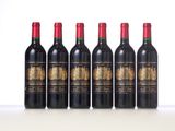 six bottles of red wine lined up in a row