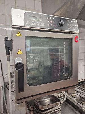 a large oven that is in a kitchen with a lot of pots and pans