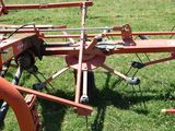 a tractor with a plow attached to it in the grass