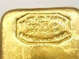 an image of a close up of a gold bar on a white surface