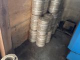 a stack of silver coils sitting in a room next to a blue refrigerator