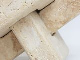 a close up picture of a sculpture made out of stone blocks