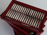 a red box that has a bunch of silver spoons in it