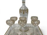 a tray with wine glasses and a decanter on it
