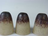 three vases that are sitting on a white surface