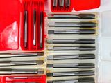 many different tools in a red case on the table