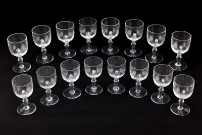 several empty wine glasses are arranged in a circle on a black surface