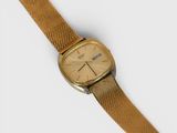 a close up of a watch on a white surface with a white background