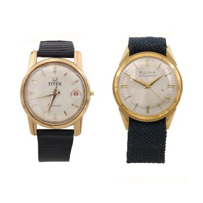 an image of a couple of watches sitting side by side on a white surface