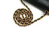 black and gold chandelier bag with chain strap on white background