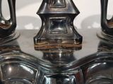 a close up of a pair of silver vases on a table