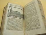 an open book with a picture of a church on it