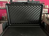 an image of a grill in a kitchen with a pink wall
