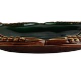 brown and green ceramic bowl with two wings on top of it