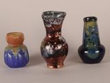 three vases sitting next to each other on a table