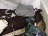 a bag of luggage sitting on top of a bed next to a pillow