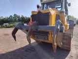 a yellow bulldozer that is parked in the dirt