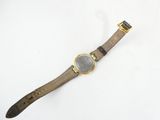 a close up of a watch on a white surface with a white background