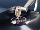 a record on a turntable with a metal handle