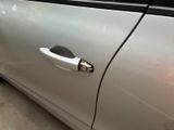 a silver car with a handle on the side of it