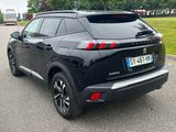 the rear end of a black suv parked in a parking lot