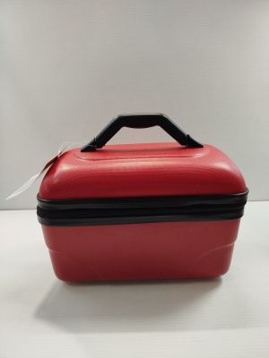 a red suitcase with a black handle on a white table