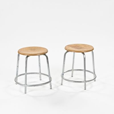 two metal stools with wooden seat on a white background