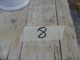 a piece of paper on a wooden table with a number on it