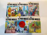 six children ' s comics are lined up on a white surface