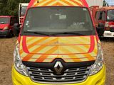 a yellow and red van parked in front of a building