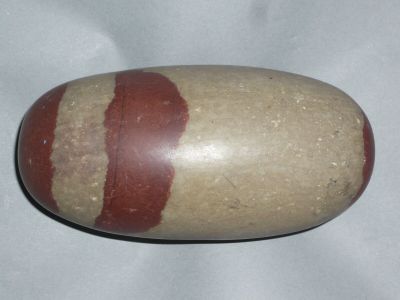 une pierre présentant une rayure rouge sur un fond blanc
