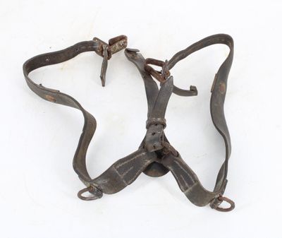 an old pair of leather harnesses on a white surface