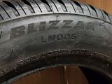 a close up of a tire on a box with a cardboard box in the background