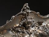 a silver vase with a bunch of flowers on it