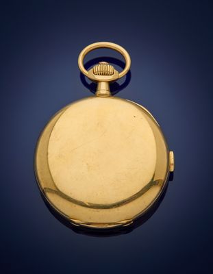 an old gold pocket watch with a chain on a blue background