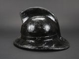 an old black helmet on a black background with a gray background