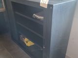 a black cabinet with a yellow tag on it