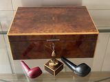 a glass table with a glass top and a wooden box with a pipe on it