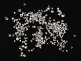 a close up of a bunch of diamonds on a black background
