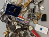 a lot of assorted watches and other items on the table