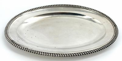 an oval silver plate with a rope edge on a white surface