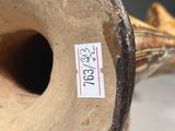 a close up of a vase with a sticker on it