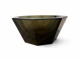 a glass bowl that is sitting on a white surface